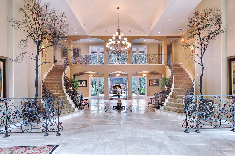 Example of a huge tuscan white floor foyer design in Orange County with beige walls