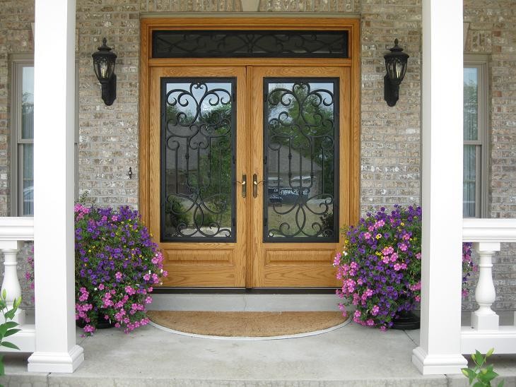 Example of a large classic medium tone wood floor entryway design in Other with beige walls and a medium wood front door