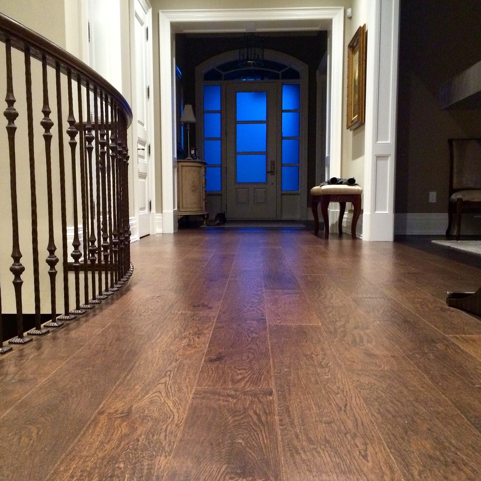 This is an example of a large traditional foyer in Toronto with beige walls, medium hardwood flooring, a single front door and a white front door.