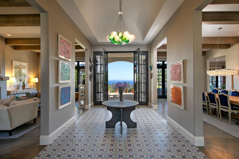 Photo of a mediterranean foyer in Santa Barbara with grey walls and multi-coloured floors.