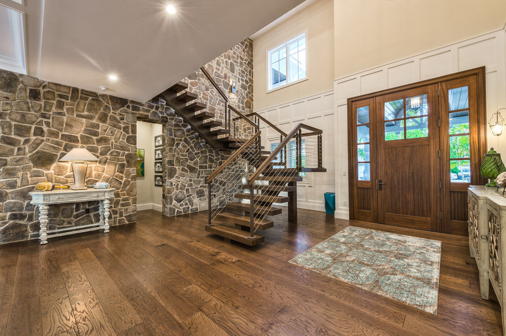 Inspiration for a large medium tone wood floor and brown floor entryway remodel in Miami with multicolored walls and a medium wood front door