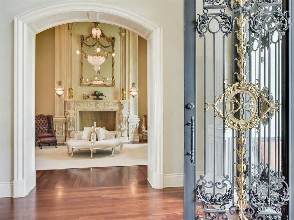 Photo of a large victorian foyer in Austin with beige walls, medium hardwood flooring, a double front door and a glass front door.