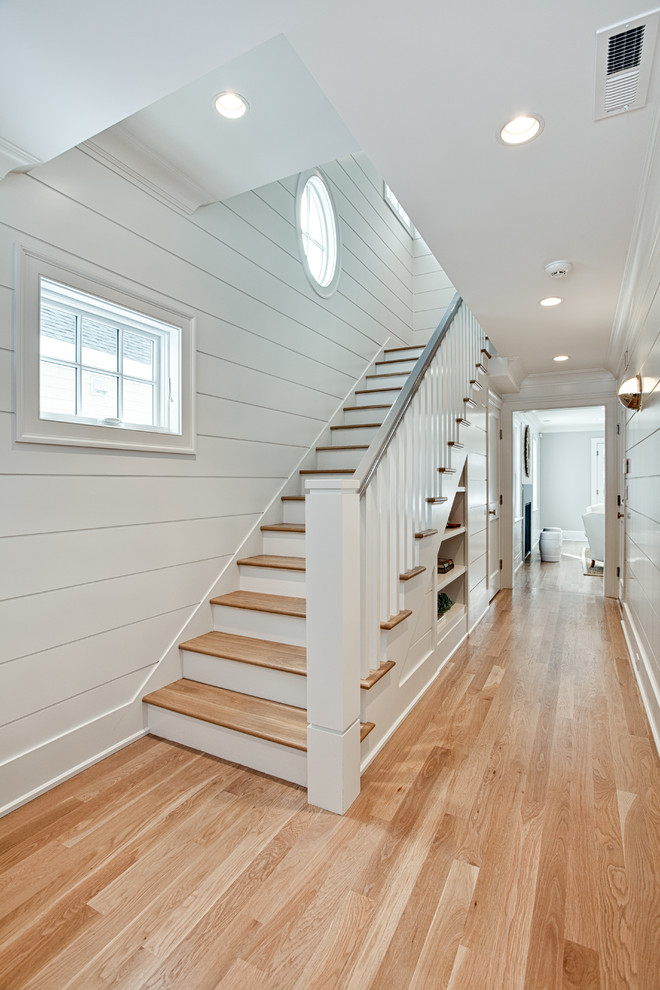Photo of a large beach style foyer in Other with white walls, light hardwood flooring, a single front door, a grey front door and brown floors.
