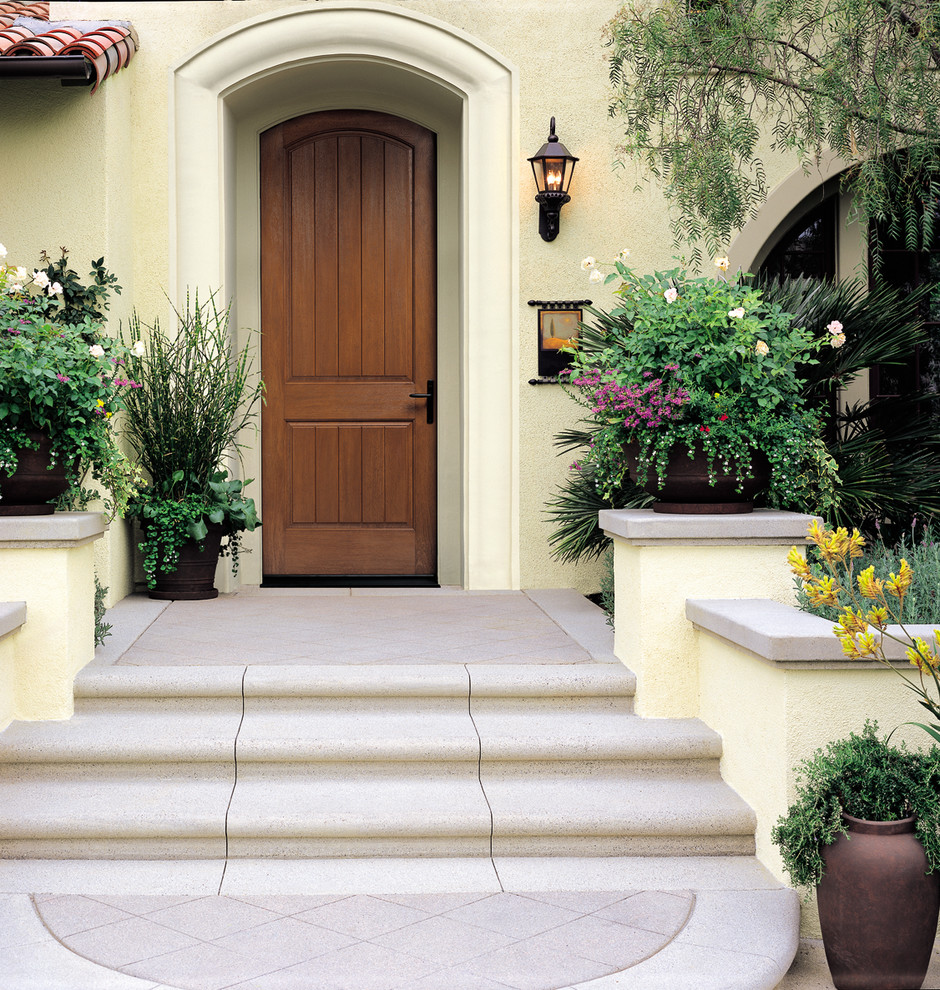 Mediterranean front door in Other with a single front door and a medium wood front door.