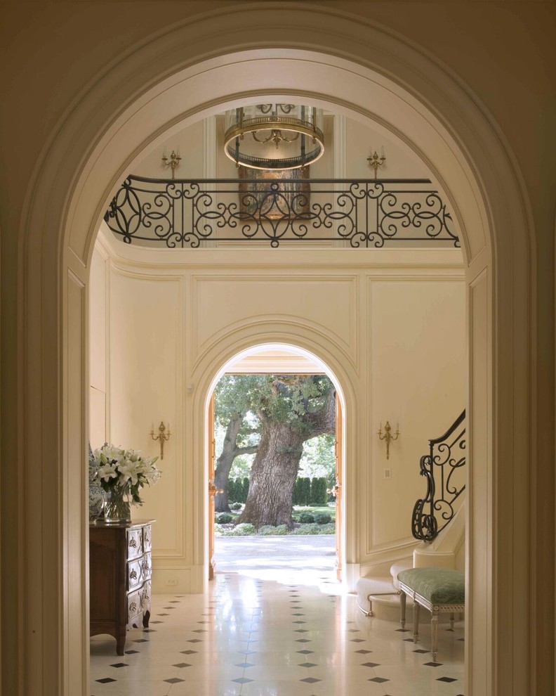 Стильный дизайн: большая узкая прихожая в классическом стиле с белыми стенами, полом из керамической плитки, двустворчатой входной дверью, коричневой входной дверью и белым полом - последний тренд