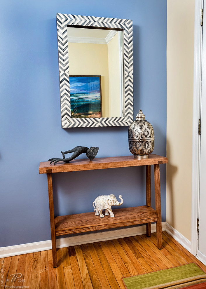 Small minimalist light wood floor entryway photo in Baltimore with blue walls