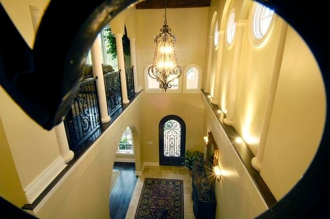 タンパにある高級な広い地中海スタイルのおしゃれな玄関 (濃色無垢フローリング、緑のドア、茶色い床) の写真