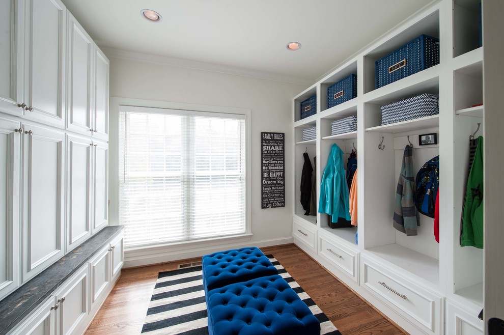 Inspiration for a medium sized classic boot room in DC Metro with white walls, dark hardwood flooring and brown floors.