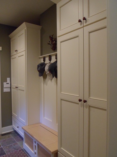 Inspiration for a timeless slate floor mudroom remodel in Grand Rapids with beige walls
