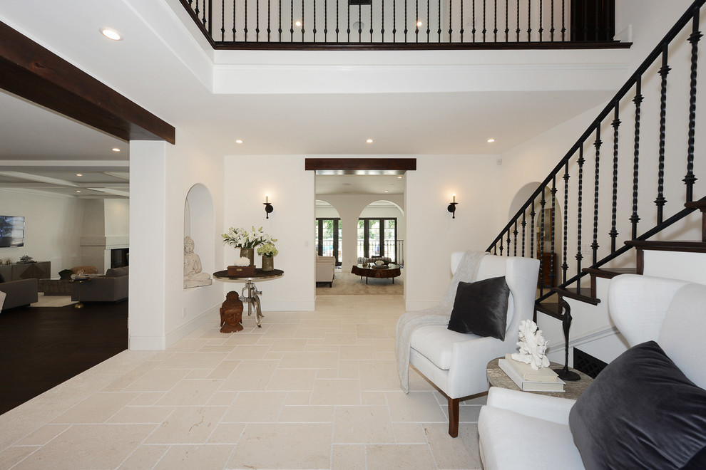 Inspiration for a medium sized mediterranean foyer in Los Angeles with white walls, marble flooring and white floors.
