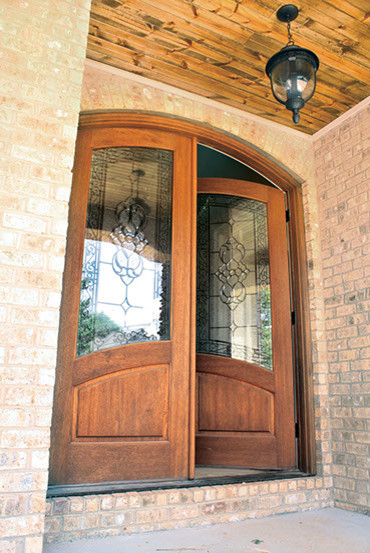 This is an example of a medium sized entrance in Tampa with pink walls, a double front door and a dark wood front door.