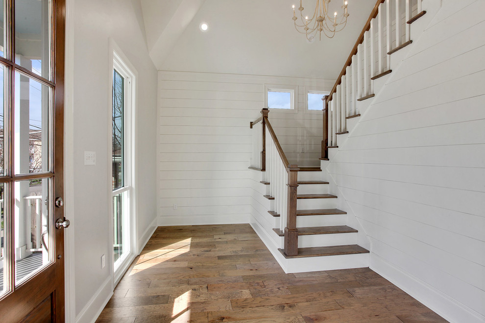 Mid-sized transitional medium tone wood floor entryway photo in New Orleans with gray walls