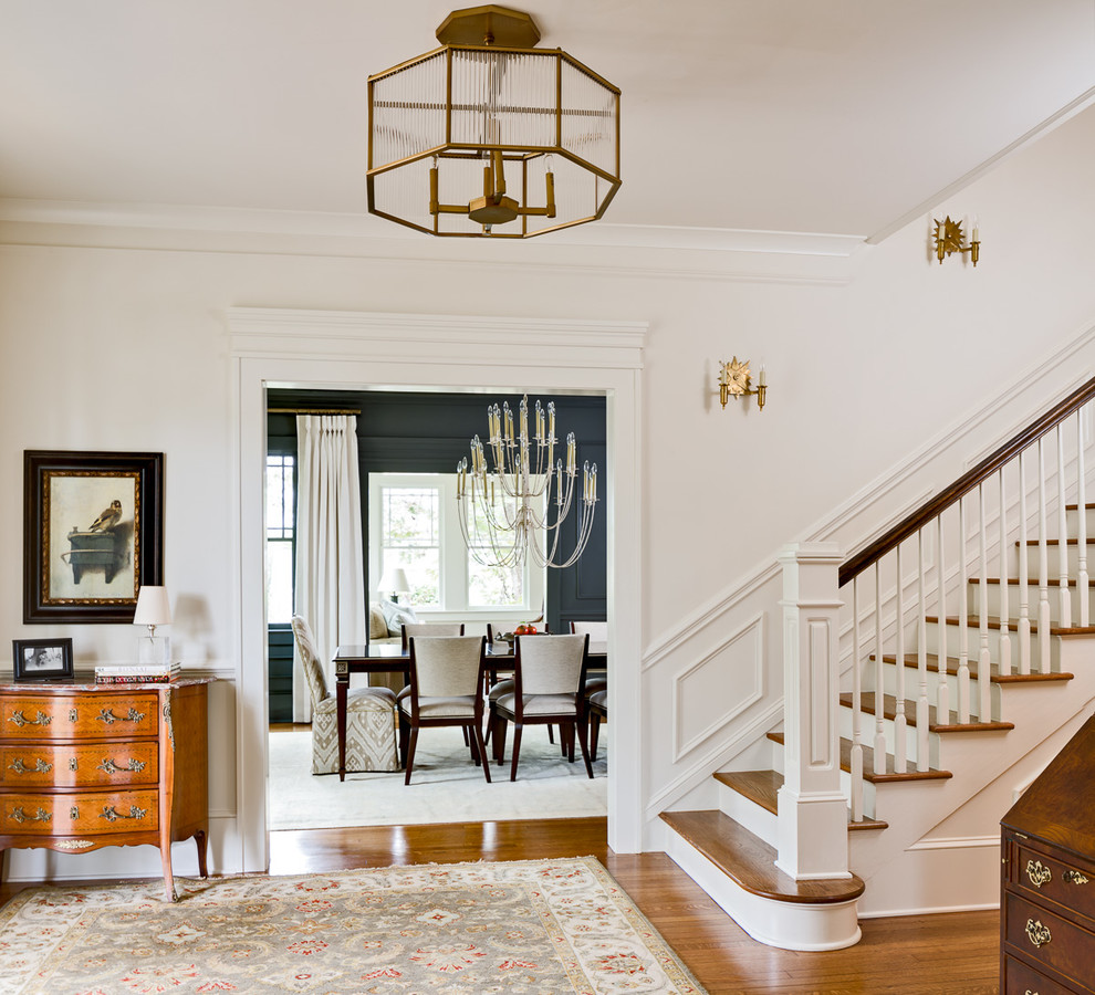 This is an example of a large traditional foyer in Atlanta with white walls and medium hardwood flooring.