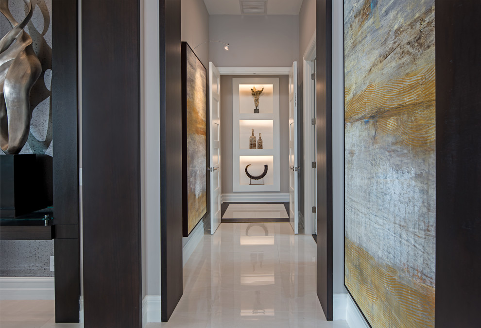 Example of a mid-sized trendy marble floor and beige floor entryway design in Orlando with beige walls and a glass front door
