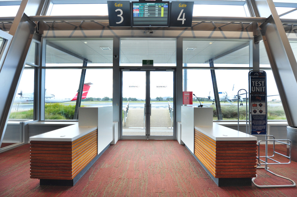 Photo of a modern entrance in Other with grey walls, carpet, a double front door, a glass front door and pink floors.