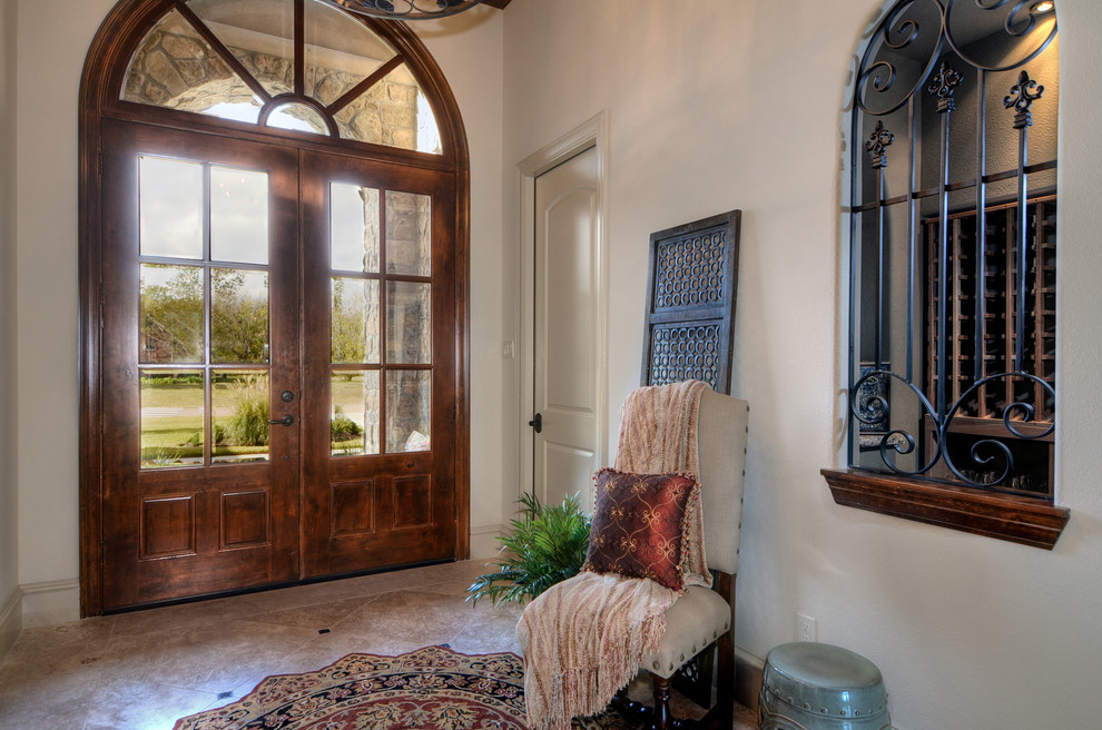 Design ideas for a large mediterranean foyer in Houston with beige walls, ceramic flooring, a double front door and a dark wood front door.