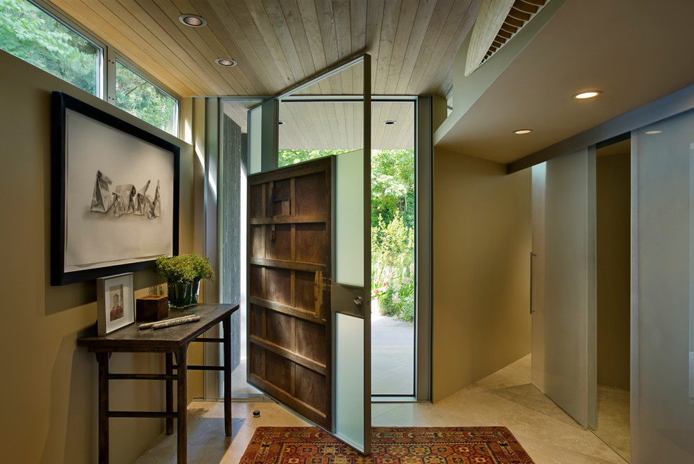 Inspiration for a contemporary entrance in Seattle with beige walls and a pivot front door.