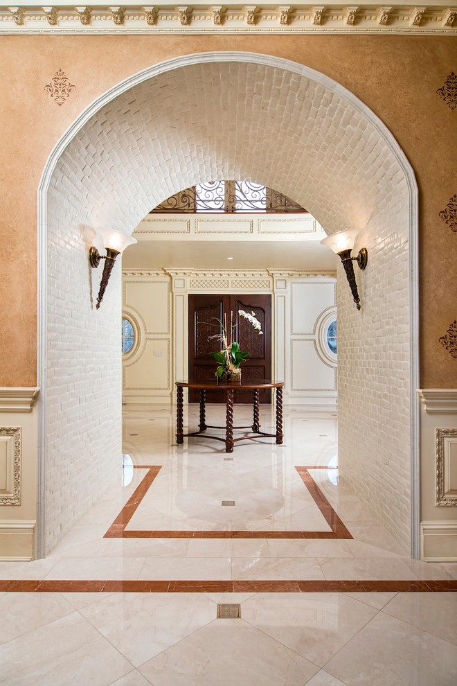 Entryway - traditional entryway idea in New York with beige walls and a dark wood front door
