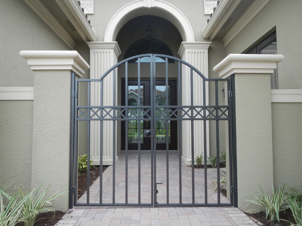 Large elegant brick floor and beige floor entryway photo in Tampa with gray walls and a dark wood front door