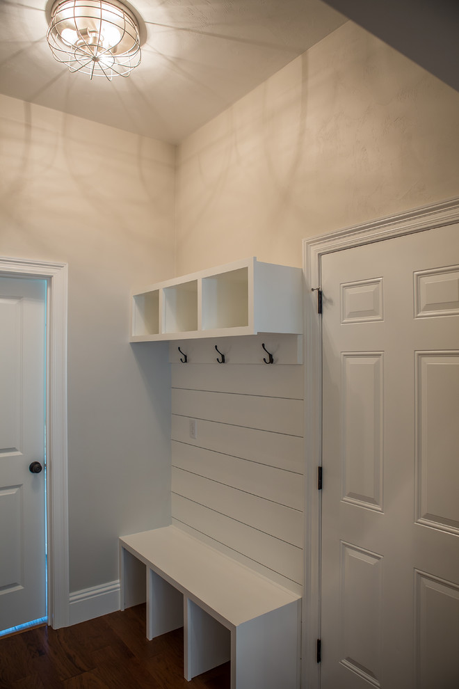 Example of a mid-sized transitional dark wood floor and brown floor entryway design in Atlanta with gray walls and a white front door