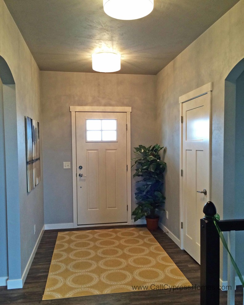 Example of a mid-sized trendy vinyl floor entryway design in Milwaukee with gray walls and a white front door