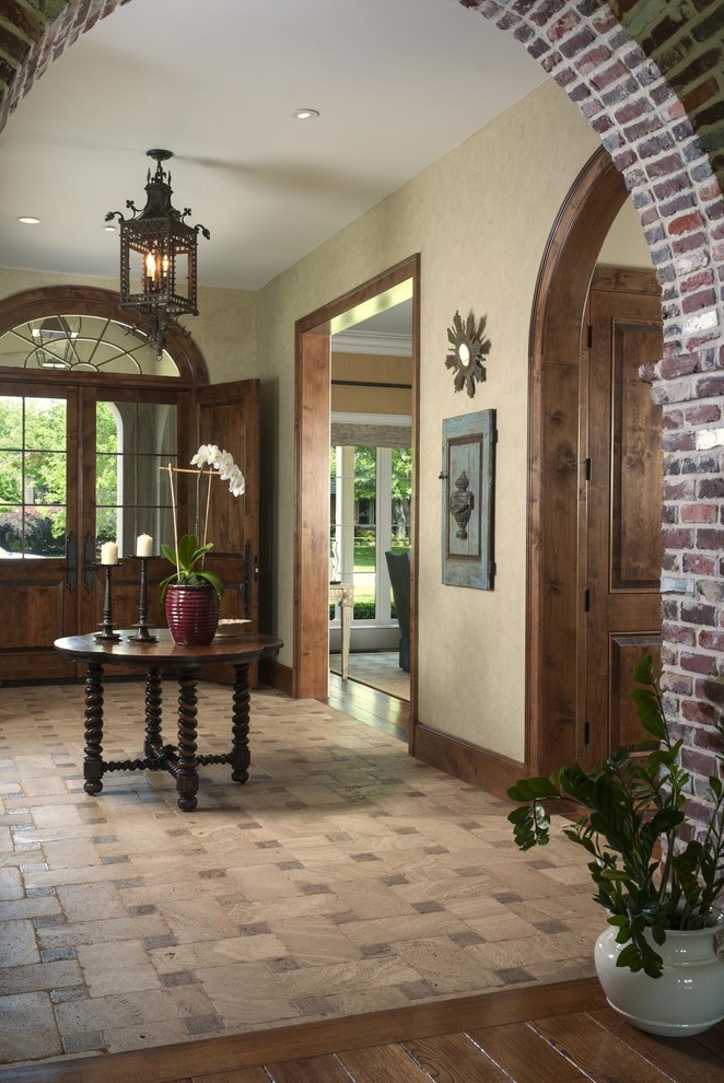 Inspiration for a mid-sized timeless medium tone wood floor entryway remodel in Dallas with beige walls and a dark wood front door