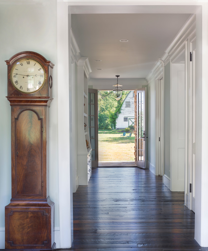 Example of a cottage dark wood floor entryway design in DC Metro with gray walls and a glass front door