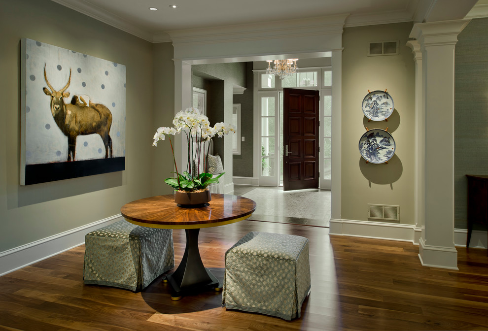 Large elegant medium tone wood floor and brown floor entryway photo in Baltimore with a dark wood front door and beige walls
