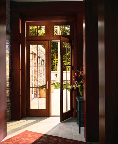 Medium sized classic front door in Omaha with brown walls, ceramic flooring, a single front door and a medium wood front door.