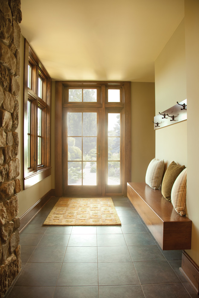 Entryway - mid-sized contemporary ceramic tile and gray floor entryway idea in Cedar Rapids with beige walls and a dark wood front door