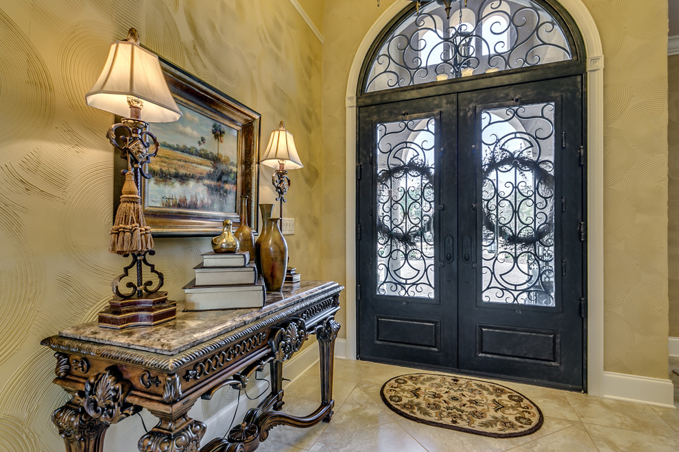 This is an example of a large mediterranean foyer in Other with beige walls, a double front door and a black front door.