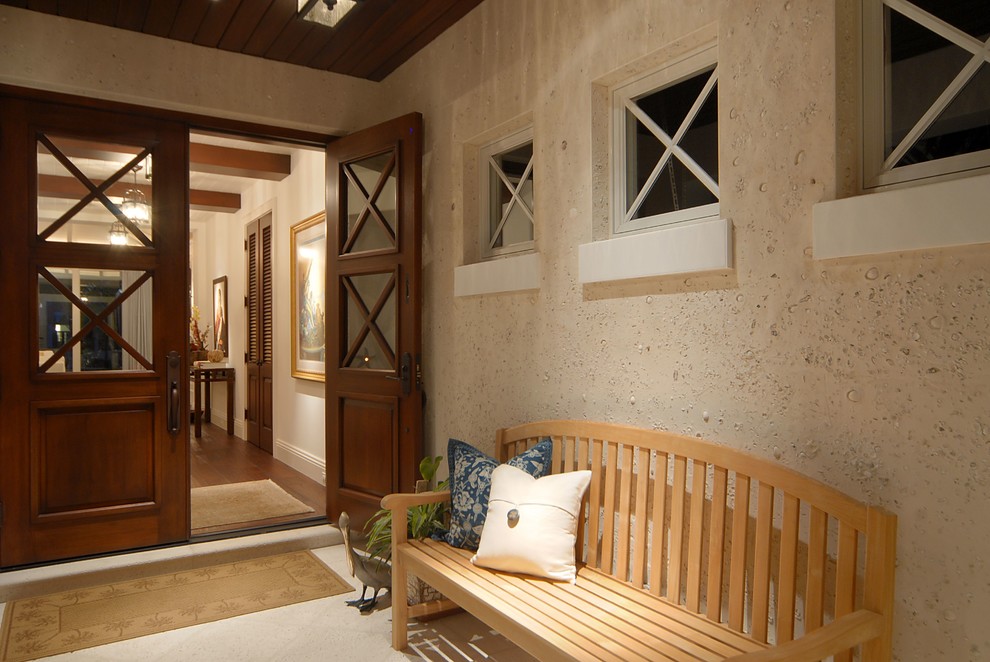 This is an example of a medium sized world-inspired vestibule in Miami with white walls, medium hardwood flooring, a double front door, a medium wood front door and brown floors.