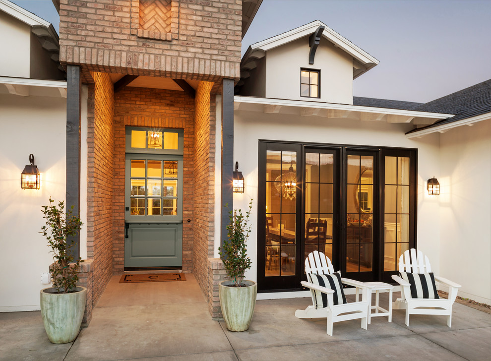 Farmhouse front door in Phoenix with white walls, concrete flooring, a stable front door and a grey front door.