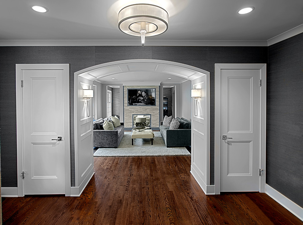 Example of a large transitional medium tone wood floor and wallpaper foyer design in Chicago with gray walls