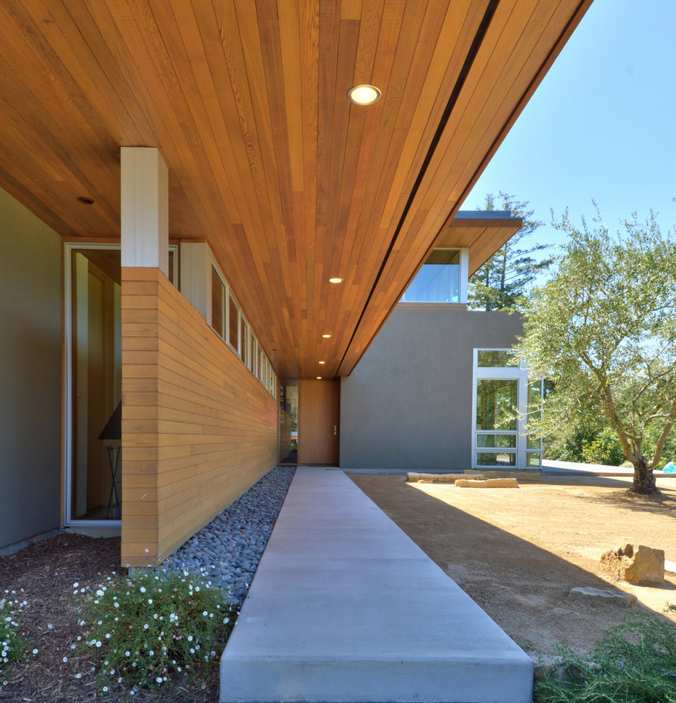 Entryway - contemporary entryway idea in San Francisco with a light wood front door