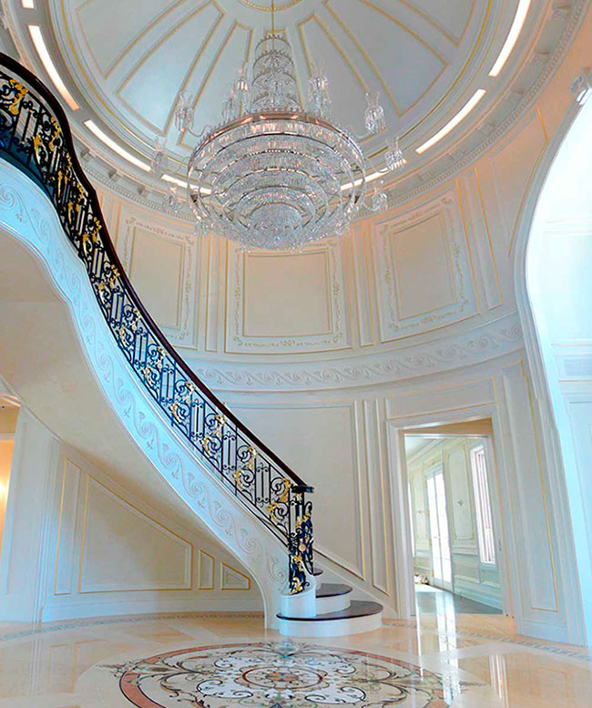 Expansive traditional foyer in New York with white walls and marble flooring.