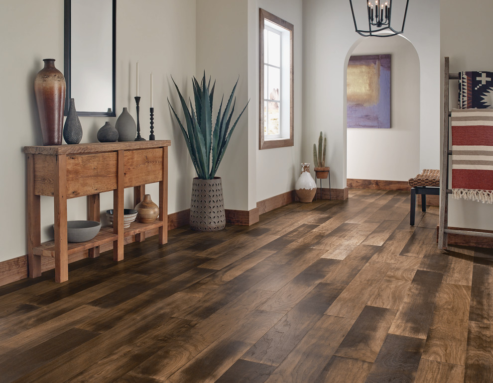 This is an example of a medium sized hallway in Los Angeles with white walls, dark hardwood flooring and brown floors.