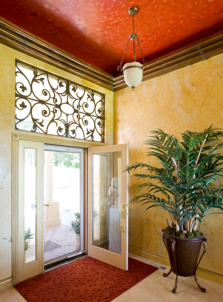 Inspiration for a large eclectic ceramic tile entryway remodel in Portland with beige walls and a glass front door
