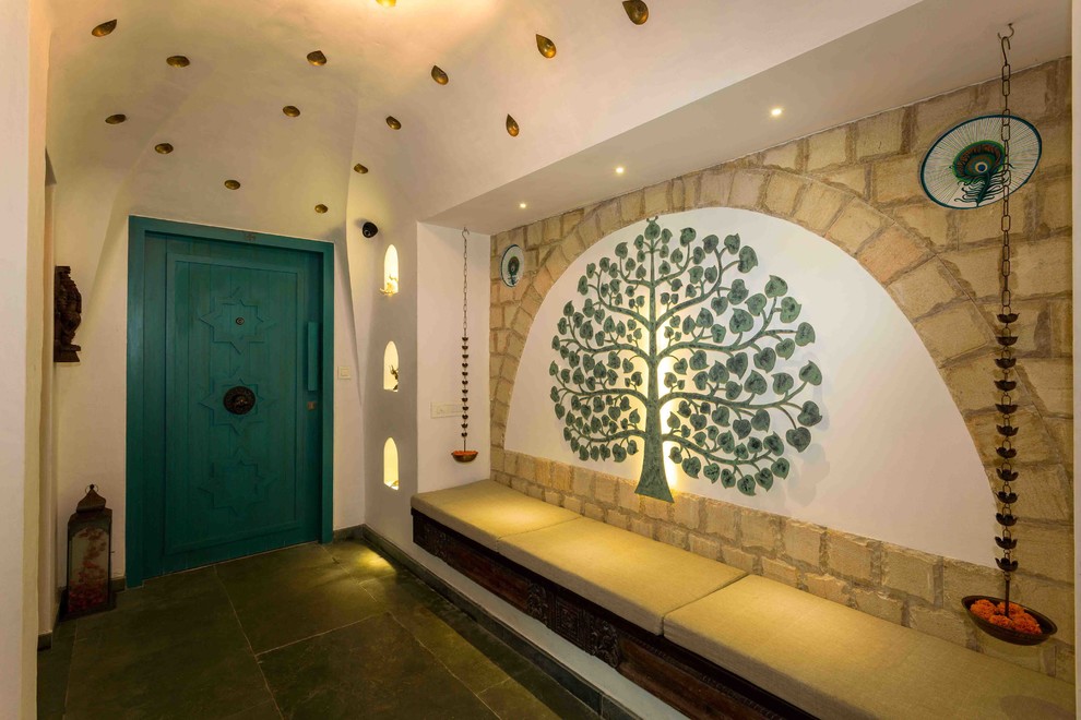 Entryway - zen entryway idea in Mumbai with white walls