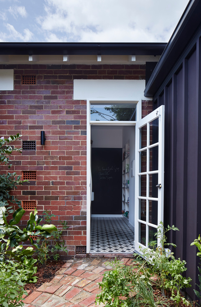 This is an example of a traditional front door in Brisbane with a single front door and a glass front door.