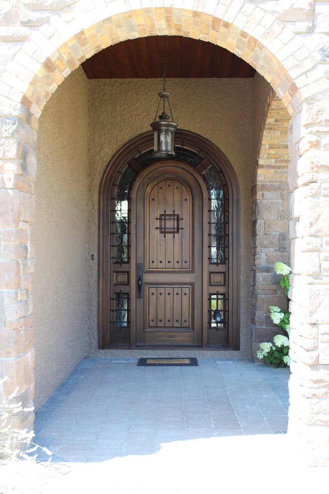 This is an example of an expansive contemporary front door in Vancouver with a single front door and a dark wood front door.