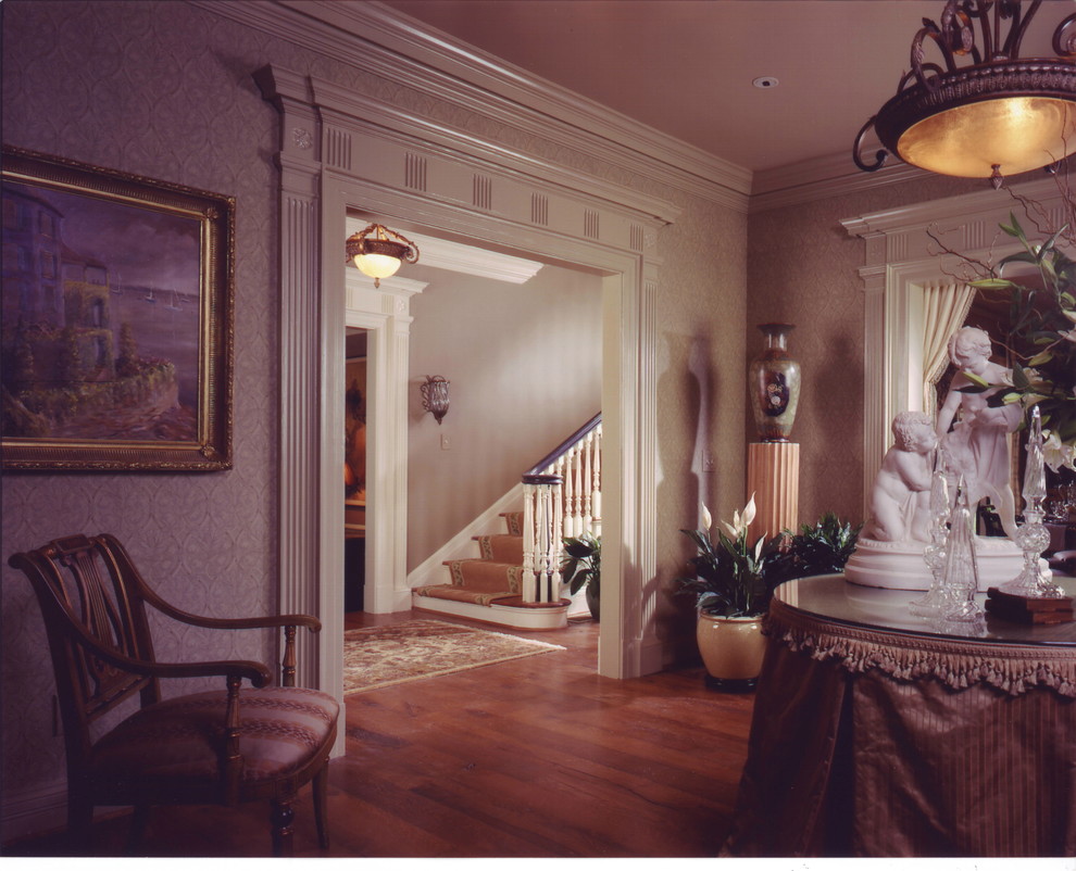 Example of a mid-sized classic medium tone wood floor foyer design in Atlanta with gray walls