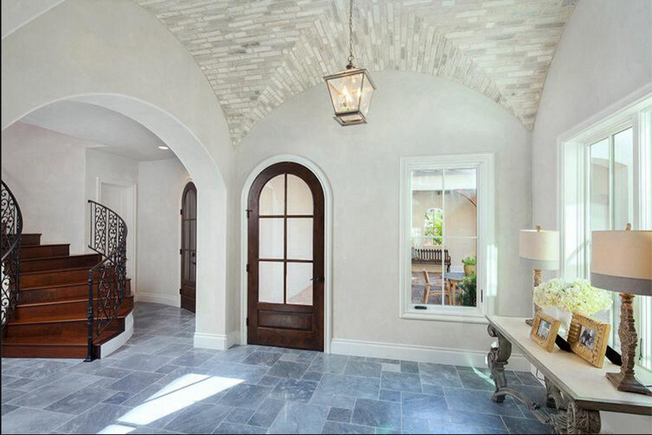 Immagine di un ingresso classico di medie dimensioni con pareti beige, pavimento in ardesia, una porta singola e una porta in legno scuro