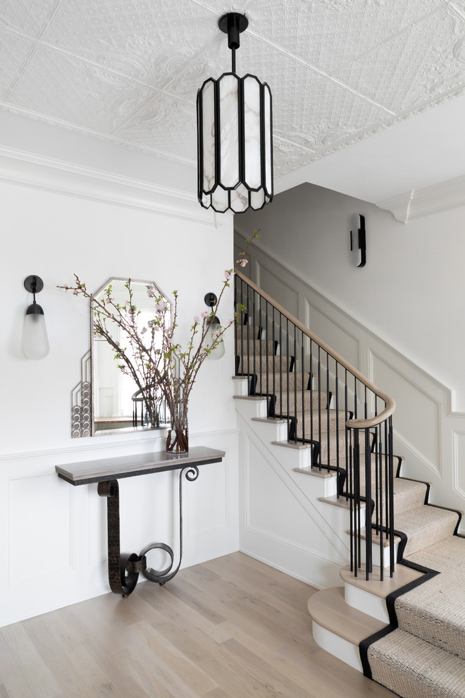 Large transitional light wood floor and beige floor foyer photo in Austin with white walls