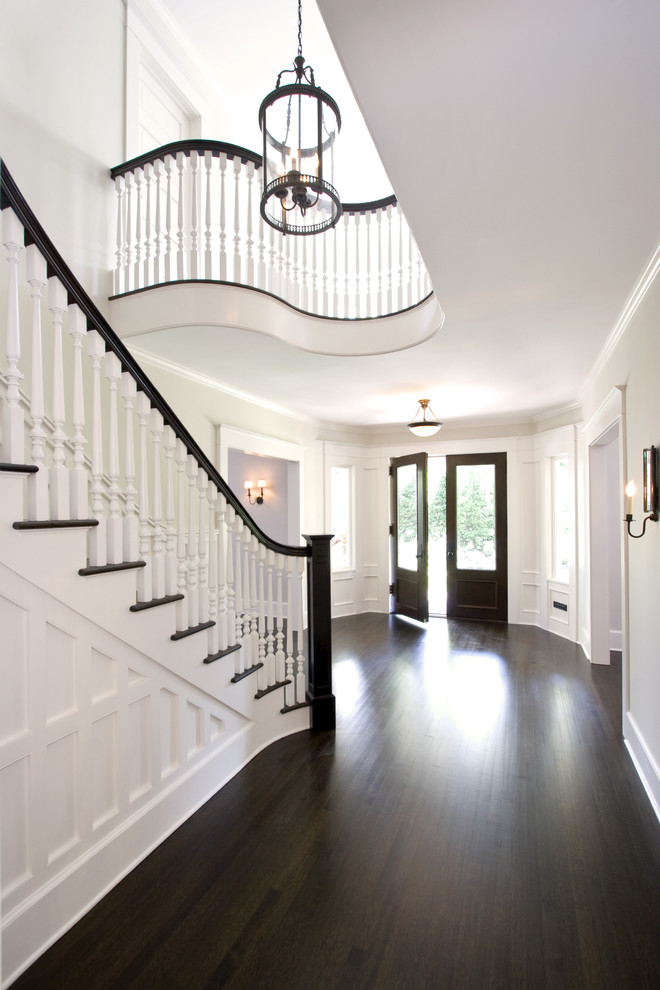 Design ideas for a large traditional foyer in New York with a double front door, grey walls, dark hardwood flooring, a dark wood front door and brown floors.