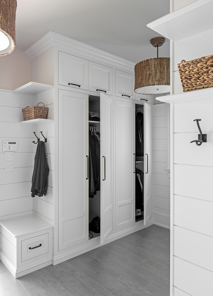 Mudroom - coastal gray floor mudroom idea in Other with white walls