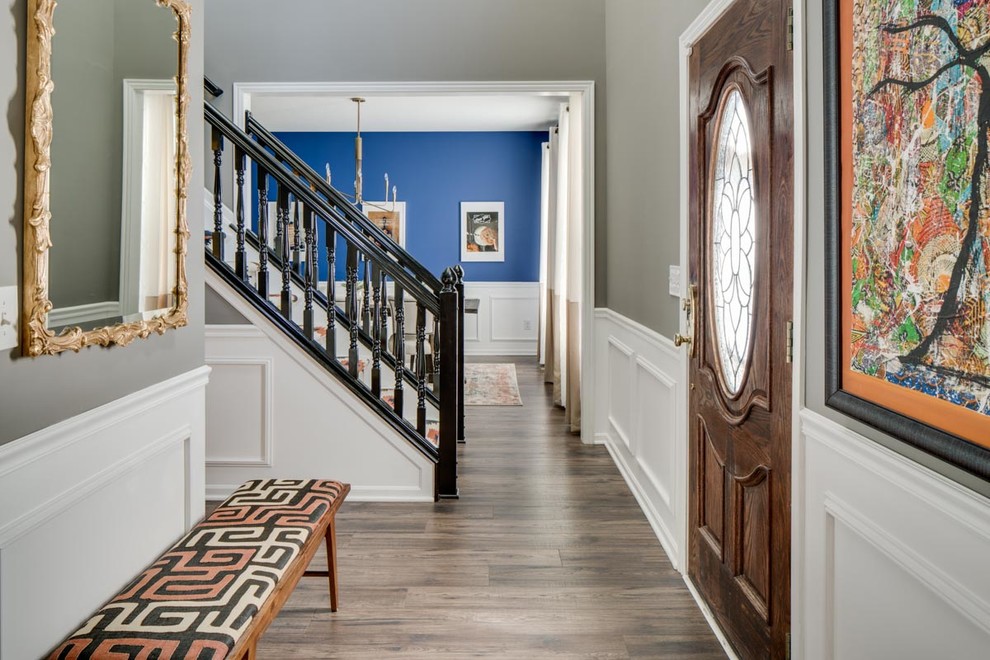 Photo of a medium sized traditional hallway in Columbus with grey walls, medium hardwood flooring and a medium wood front door.