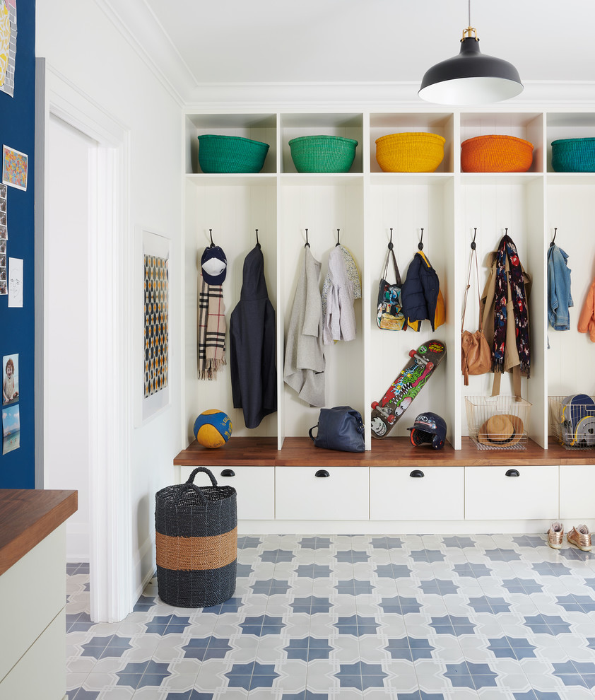Example of a classic multicolored floor mudroom design in Toronto with white walls