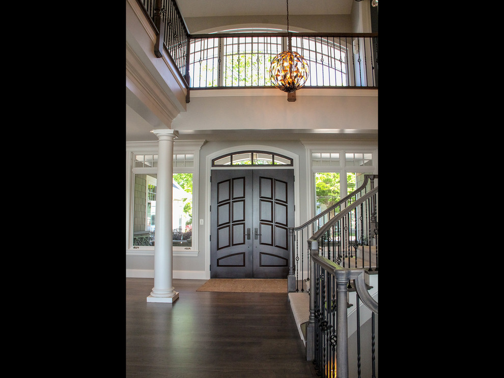 Design ideas for a large beach style front door in Other with grey walls, dark hardwood flooring, a double front door, a dark wood front door and brown floors.