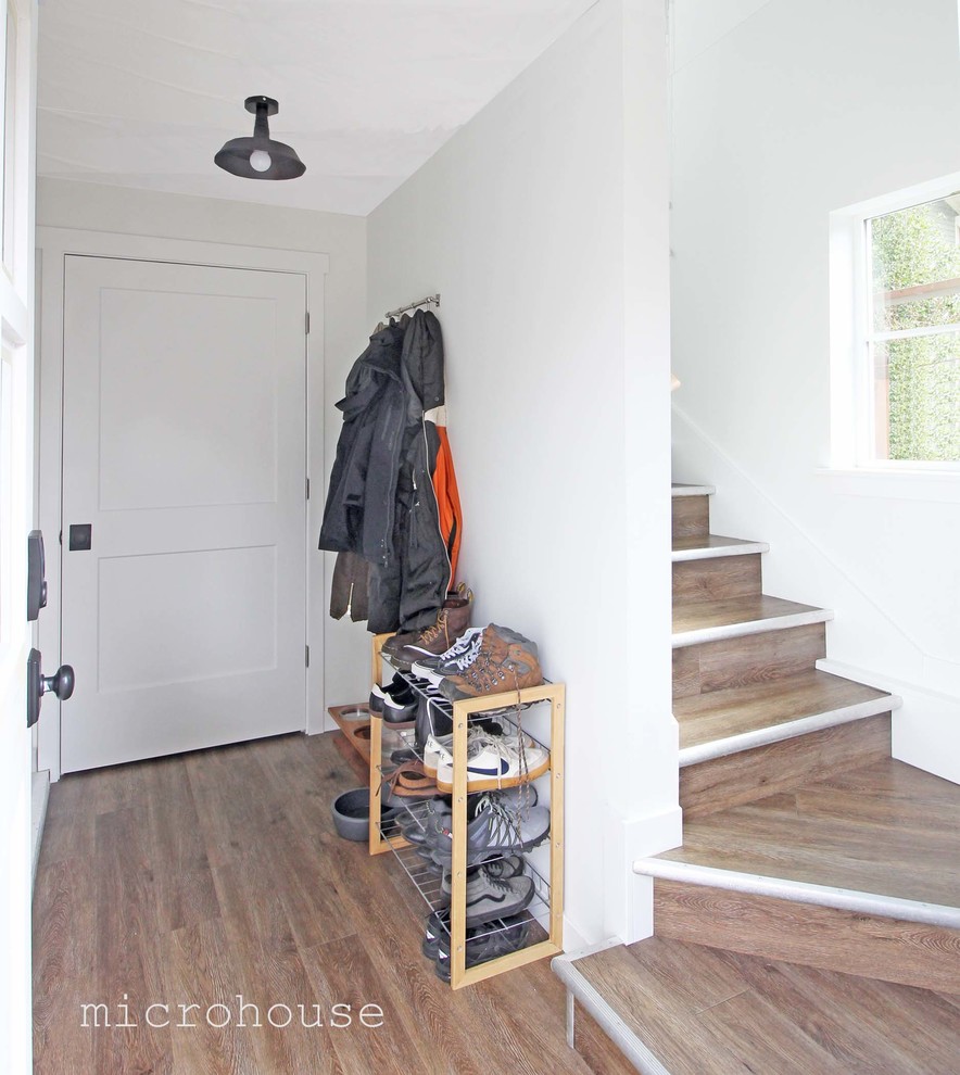 Photo of a small farmhouse foyer in Seattle with laminate floors.